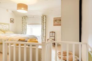 a bedroom with a bed and a white crib at 2 Bed in Buxton oc-dcbap in Longnor