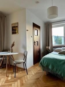 a bedroom with a bed and a table and a chair at POKLEKANE in Wysowa-Zdrój +17 photos