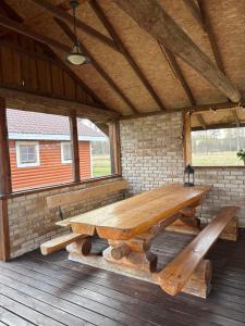 a large wooden picnic table on a deck at 5 bedroom house in Roosisaare