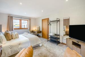 a bedroom with a large bed and a flat screen tv at 3 Bed in Pitlochry oc-t37864 in Pitlochry