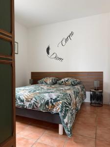 a bedroom with a bed with a sign on the wall at Hacienda in Caumont +5 photos