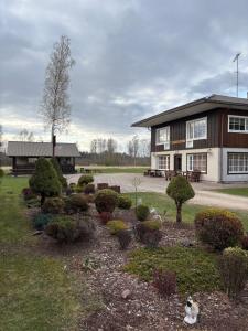 a building with a bunch of bushes in front of it at 5 bedroom house in Roosisaare