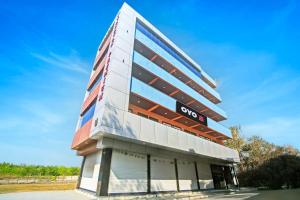 a building with aoc sign on the side of it at Hotel O Tanatan Premium in Bhopal +21 photos