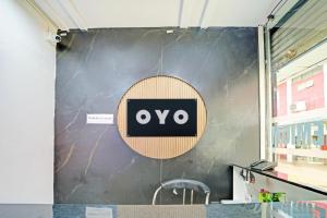 a wall with an ovo sign on it at Hotel O Tanatan Premium in Bhopal