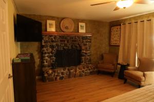 a living room with a fireplace and a television at Dumplin Patch Bed & Breakfast in Williams