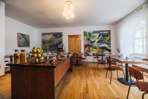 a restaurant with a bar with tables and chairs at Filek House in Sibiu