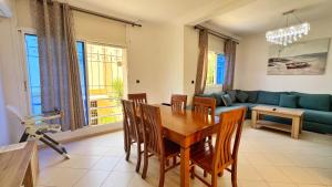 a living room with a table and a couch at Spacious Triplex in Harhoura in El Harhoura