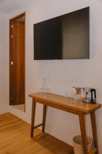a wooden table with wine glasses on a wall at Hotel Boutique Casa Yága in Querétaro +59 photos