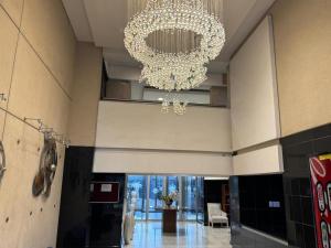 a large chandelier in a building with a lobby at Palm Continental Hotel in Johannesburg