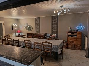 a dining room with a table and chairs at La maison de Keralies in Pleumeur-Bodou
