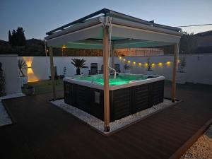 a hot tub in a gazebo on a deck at Estate - Villa Discovery in Ljubuški