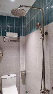 a bathroom with a shower and a toilet in it at Mik Stay 2 in Danang