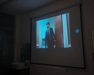 a television screen with a man in a suit on it at Mik Stay 2 in Danang