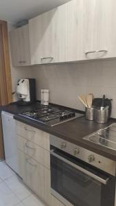 a kitchen with a stove and a counter top at Trilogy b&b in Celano +36 photos
