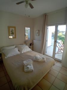 a bedroom with a bed with towels on it at Aethalios katoikia in Korissia