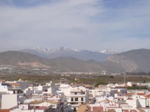 a view of a city with mountains in the background at Pensión Mari Carmen in Salobreña +34 photos