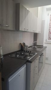a kitchen with a stove and a counter top at Trilogy b&b in Celano