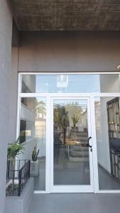 a sliding glass door of a building at Apart Z Alberdi in Belén de Escobar