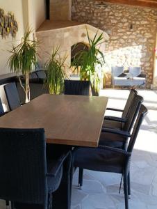 a wooden table and chairs in a restaurant at Villa Olea in Mostar