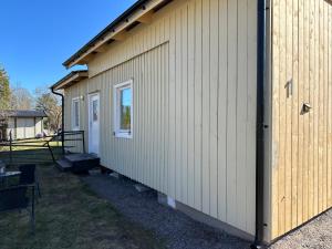 a side view of a building with a door at Stuga Älvkarleby,Älvkarleö in Älvkarleby +3 photos