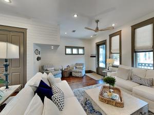 a living room with a white couch and a table at The Holland House II in Rosemary Beach +28 photos