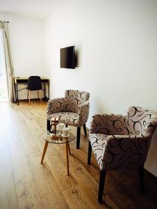 a living room with two chairs and a table at Villa Olea in Mostar