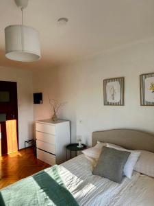 a bedroom with a bed and a white dresser at POKLEKANE in Wysowa-Zdrój