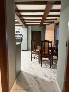a kitchen and dining room with a table and chairs at Malva in Grado