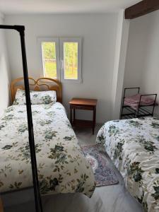 a bedroom with two beds and a table at Malva in Grado