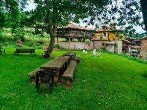 a group of benches in a field with a tree at Malva in Grado