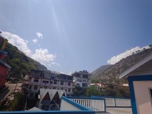 a view from the balcony of a town with mountains at Yang home stay in Dirang Dzong