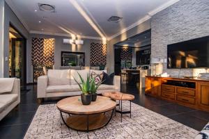 a living room with a couch and a table at LeoLapa in Hectorspruit