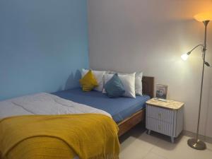 a bedroom with a bed with a blue wall at KalaKoala Hostel in Malang +54 photos