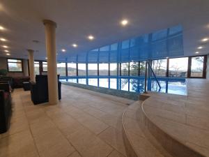 a large building with a pool in the middle at Hotel HAVLOV in Žďárec
