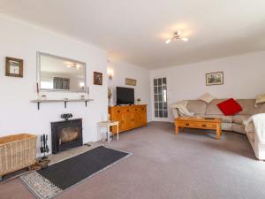 a living room with a couch and a fireplace at Tregoning in Lostwithiel