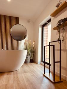 a bathroom with a large tub and a large window at Nid cosy en forêt in Blaimont +36 photos