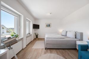 a living room with a bed and a window at Chalet Seewald - Apartment in Seewald