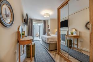 a bedroom with a bed and a mirror at 3 Bed in Amble oc-h36627 in Amble