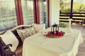 a table with a white table cloth and wine glasses at Bistrički mir - Imanje in Bistrica +6 photos