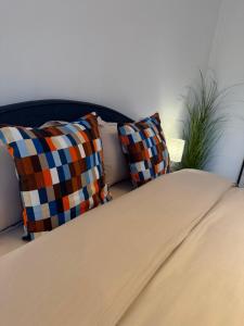 a bed with two pillows on top of it at Otopeni Studios C2 2 Airport Therme in Otopeni