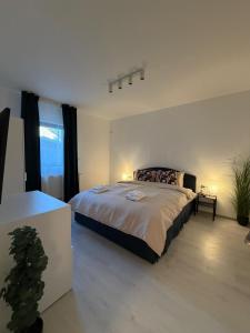 a bedroom with a large bed and a window at Otopeni Studios C2 2 Airport Therme in Otopeni
