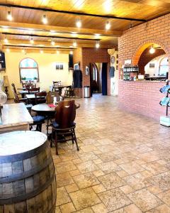 a room with tables and chairs and a brick wall at Gościniec Piast Pokoje i Camper Park in Brzeźno