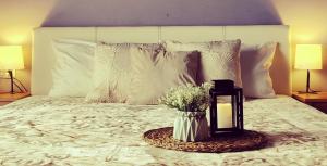 a bedroom with a bed with a vase of flowers at Bistrički mir - Imanje in Bistrica