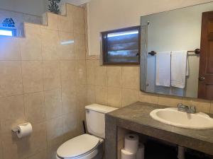 a bathroom with a toilet and a sink at Casitas Las Palmas - Brisa Marina in Punta Mita +22 photos