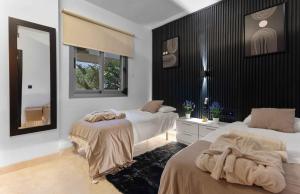 a bedroom with two beds and a mirror at VIP AL FATTAh LUXURY in Estepona +38 photos
