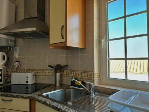 a kitchen with a sink and a window at Al Mare Ocean View in Albufeira +30 photos