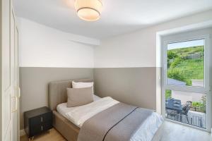 a small bedroom with a bed and a window at Kaisers Haus in Vogtsburg