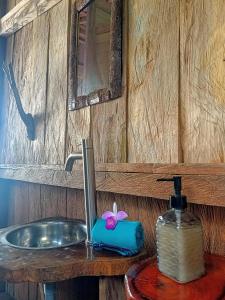 a bathroom sink with a soap dispenser next to it at Lodge El Amargal - Reserva Natural, Ecoturismo & Surf in Nuquí +85 photos