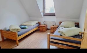 a bedroom with two beds and a window at E&B Pension in Ganderkesee