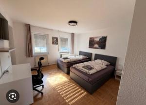 a bedroom with a bed and a couch at E&B Pension in Ganderkesee